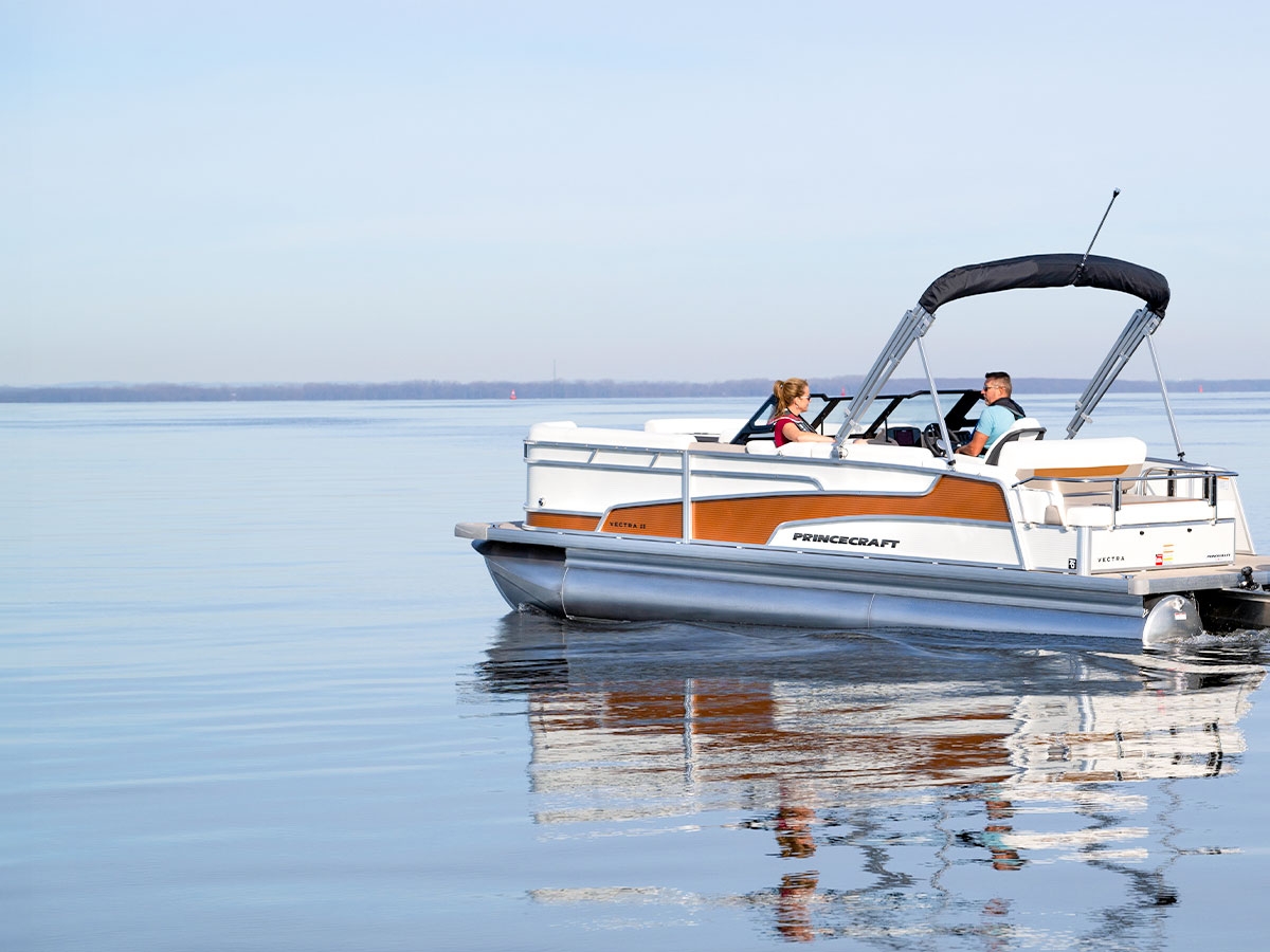 Princecraft pontoon on still water